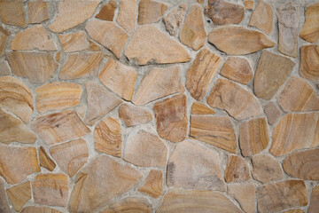 Yellow Stone wall as a background or texture