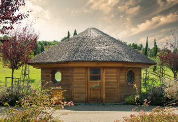 Fototapeta na wymiar Small cute wooden cabin. Tiny house in the park.