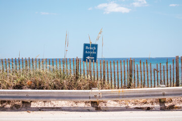 Beach access sign on coastal road in Florida