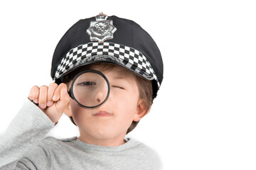 Boy with magnifying glass in hand on white background. Investigation concept