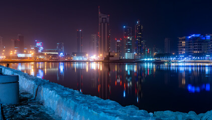 Fototapeta na wymiar Panorama of the Manama, Bahrain city skyline at night from the Reef Harbor