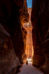 Glimpse of the Treasury seen through the slot canyon Siq in Petra, Jordan - obrazy, fototapety, plakaty