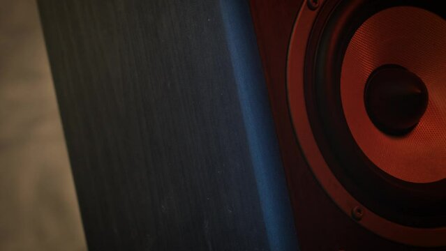 Close-up shot of a speaker woofer, rotating. A perspective natural video footage of analog equipment, symbol of music and sound