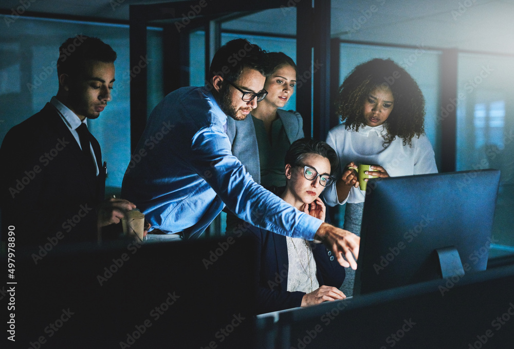 Aufkleber its taking longer than we thought. shot of colleagues standing together as they work on something on