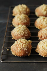  Sweet breakfast rolls with crumble on a black background, pastry shop.