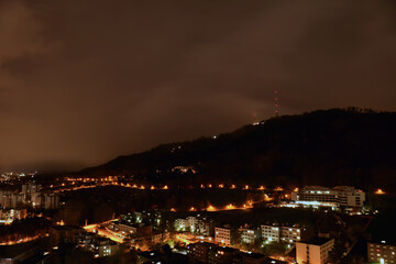 Fototapeta premium Panorama of the Uetliberg at night with an illuminated panorama trail