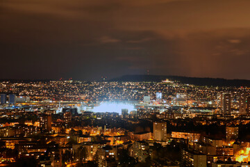 Panorama of Zurich city at night with Letzigrund football stadium