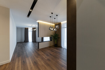 Interior design spacious bright studio apartment in Scandinavian style and warm pastel white and beige colors. trendy furniture in the living area and modern details in the kitchen area.