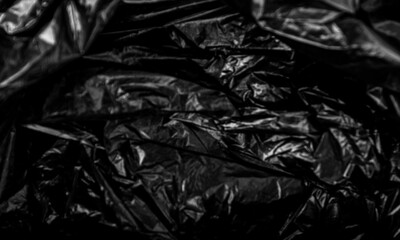 black plastic bag texture, wrap texture on a black background wallpaper, wrinkled plastic pattern for creative and decorative design