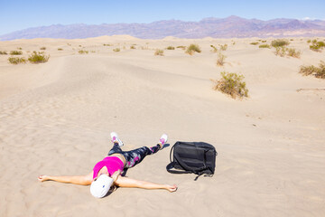 Woman dying of thirst and heat in the desert at Mesquite Dunes the Death Valley National Park. 