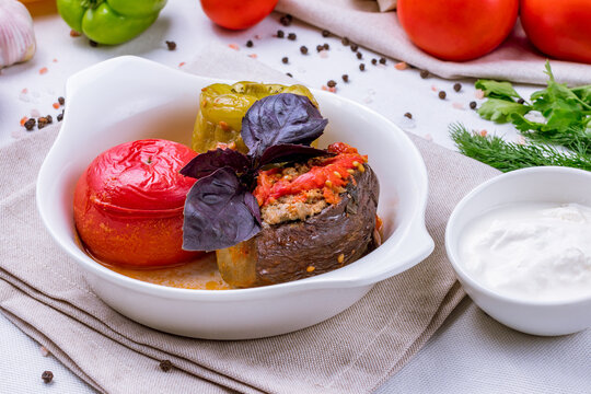 dolma in azerbaijani, meat in grilled vegetables on a white plate