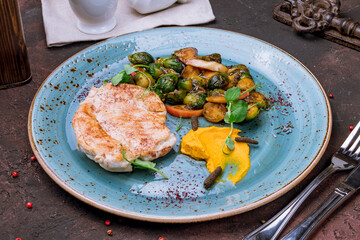 Fried chicken breast with brussels cabbage on blue plate