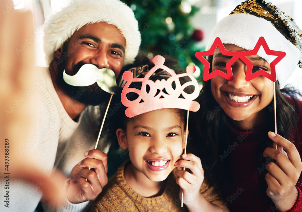 Wall mural on christmas day, we jingle all the way. shot of a happy young family celebrating christmas at home.