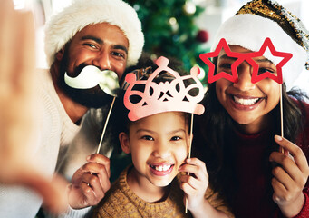 On Christmas day, we jingle ALL the way. Shot of a happy young family celebrating Christmas at home.