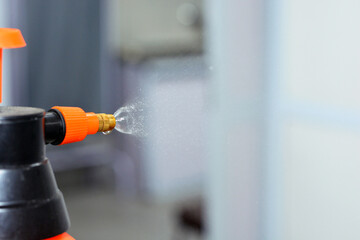 A close up of a balloon spray with a disinfectant antiseptic solution to sanitize surfaces, doors...