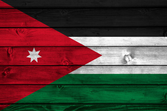  Flag of Jordan on wooden surface
