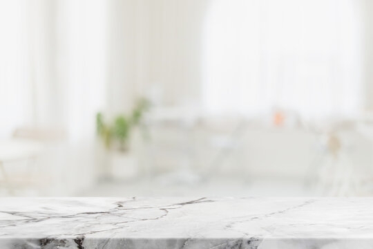 Empty white marble stone table top and blur glass window interior restaurant banner mock up abstract background - can used for display or montage your products.