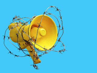 megaphone wrapped in barbed wire. the concept of banning freedom of speech. censorship barbed wire...