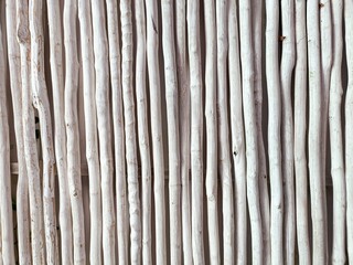Natural unfinished white sticks lined up side by side horizontal background pattern