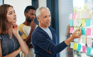 Dont wait for opportunity, create it. Cropped shot of a group of businesspeople having a brainstorming session.
