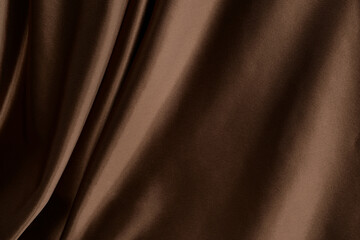 Brown silk, satin. Beautiful background with fabric chocolate color. Brown fabric, curtains, pleats, draperies