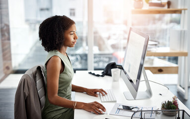 Getting results are always a priority. Shot of a young businesswoman working at her desk in a...