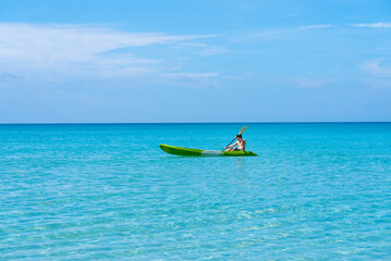 Rear View of Adult Man Kayaking in Blue Sea in Summer