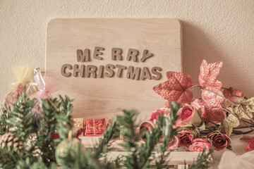 Text the word Christmas decorated with beautiful flowers and more.