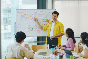 Group of young Asian business people meeting in casual wear working together on new project.