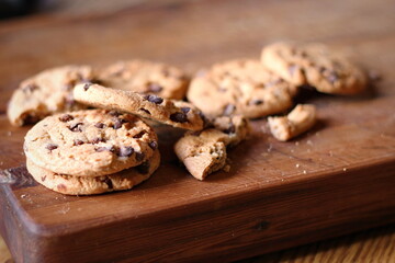 Delicious chocolate cookies placed on a wooden table