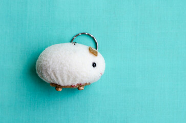 A quirky guinea pig souvenir against an aquamarine backdrop, capturing the essence of ecuadorian...