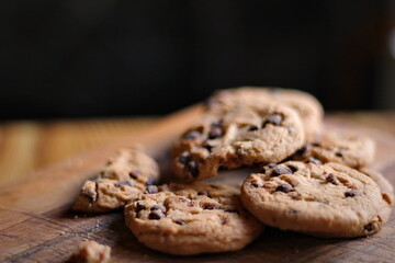 Delicious chocolate cookies placed on a wooden table