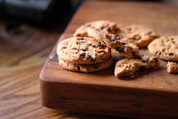 Delicious chocolate cookies placed on a wooden table