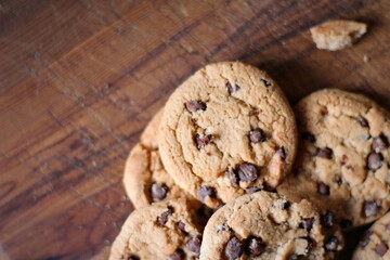 Delicious chocolate cookies placed on a wooden table