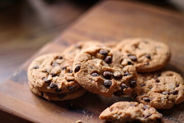Delicious chocolate cookies placed on a wooden table