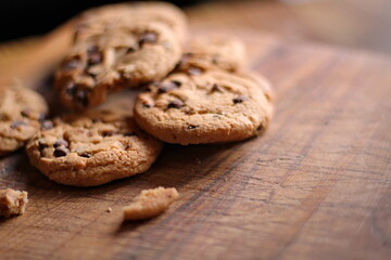 Delicious chocolate cookies placed on a wooden table