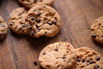 Delicious chocolate cookies placed on a wooden table