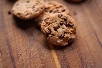 Delicious chocolate cookies placed on a wooden table