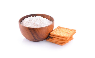 Wheat flour in wooden bowl and biscuits isolated on white background.