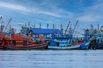Fototapeta premium A group of fishing boats moored in the harbor to avoid the monsoon in Thailand at Samet island in Khao Laem Ya - Ko Samet National Park in Thailand.