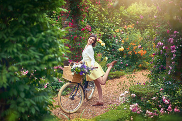 Being outdoors definitely puts a spring in my step. Shot of an attractive young woman riding a bicycle outdoors. - obrazy, fototapety, plakaty