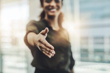 The pleasure is all mine. Cropped shot of an unrecognizable businesswoman gesturing a handshake in a modern office.