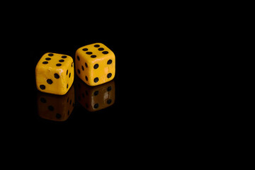 Gambling. Two dice on a black background with reflection