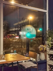 On the steamy window of cafe, wrote with finger NO WAR. Support for Ukraine against russian war and aggression.