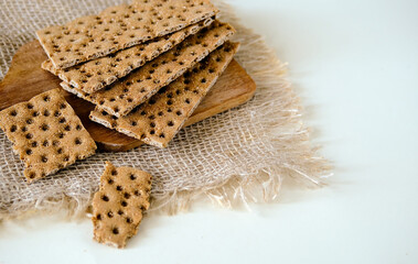 Rye crispbread. Crispy dry bread. Crispbread for sandwiches. Bread replacement. Light background. Side view.