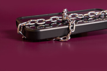 Nomophobia. The smartphone is rewound by a chain 