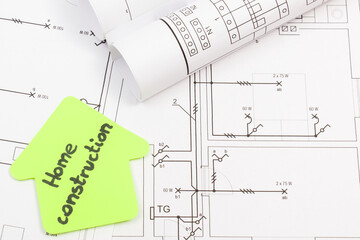 House shape made of paper with inscription home construction and electrical housing plan. Building...