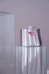 Glass goblet with a drink on a glass table