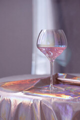 Glass goblet with drink on cloth