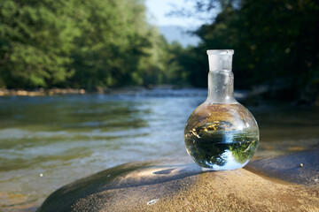 Flask with clear river water.
